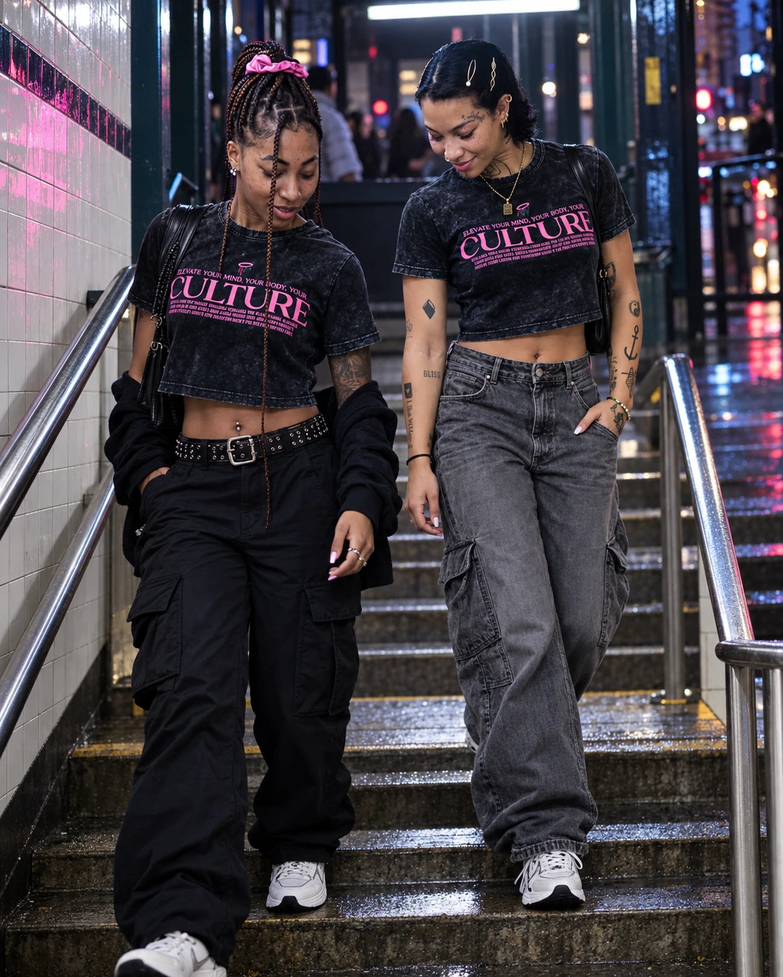 Two friends wearing New History Culture tees in a city subway stairwell